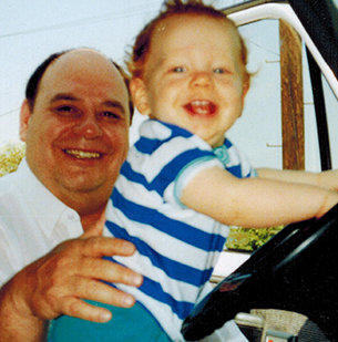 Baby Miles playing in the cab with his dad Big Bob watching